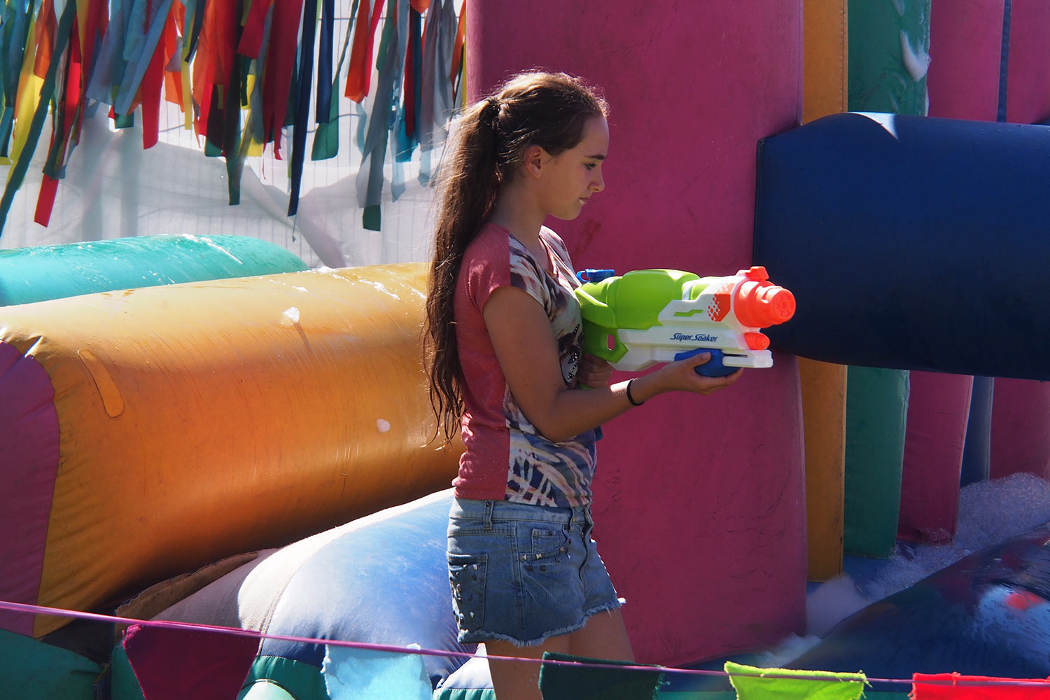 P0054548-2016-08-12-suedengland-boomtown-kidztown-huepfburg Hüpfburg-Fräulein in Kidztown . Boomtown Fair . Matterley Estate bei Winchester . Sussex . Südengland (Foto: Andreas Kuhrt)